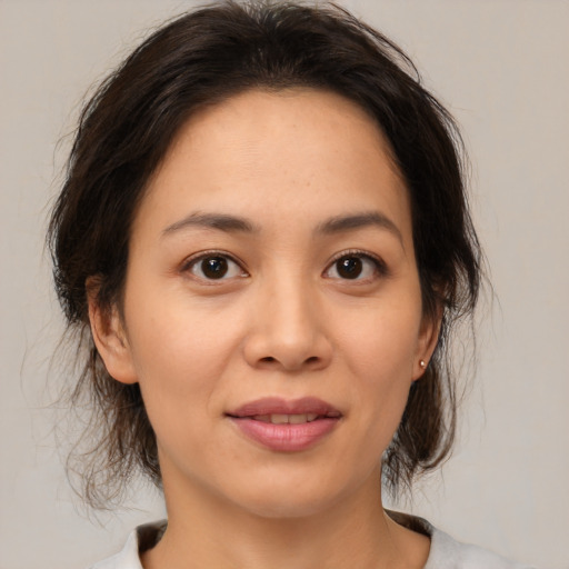 Joyful asian young-adult female with medium  brown hair and brown eyes