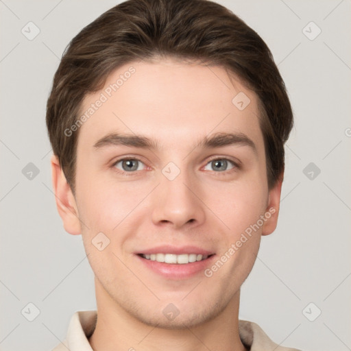 Joyful white young-adult male with short  brown hair and grey eyes