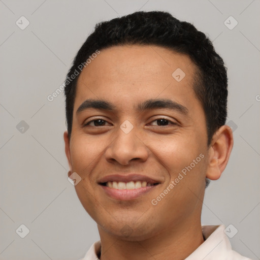 Joyful latino young-adult male with short  black hair and brown eyes