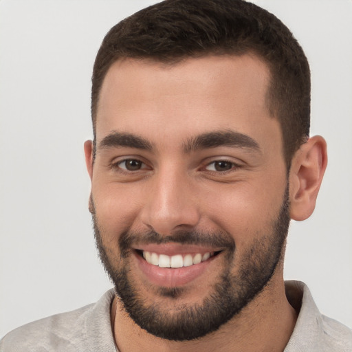 Joyful white young-adult male with short  brown hair and brown eyes