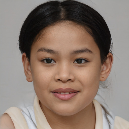 Joyful asian child female with medium  brown hair and brown eyes