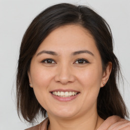 Joyful white young-adult female with medium  brown hair and brown eyes