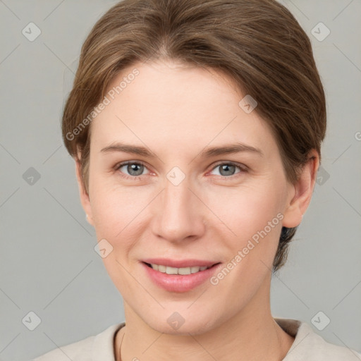 Joyful white young-adult female with short  brown hair and grey eyes