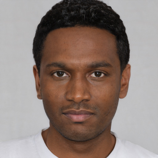 Neutral black young-adult male with short  black hair and brown eyes