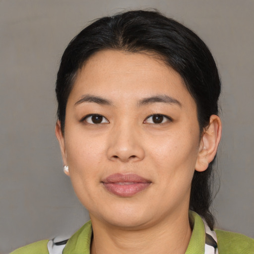 Joyful asian young-adult female with short  black hair and brown eyes