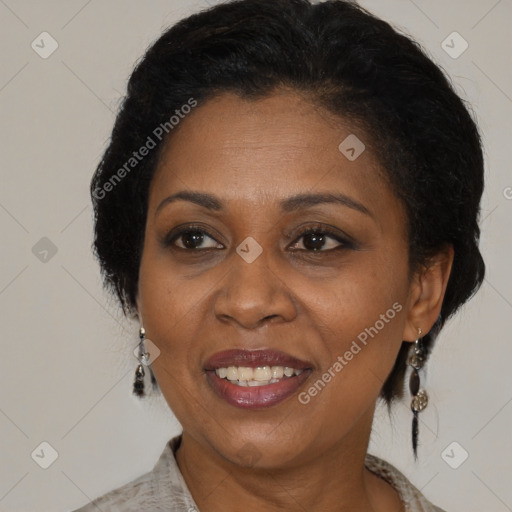 Joyful black adult female with medium  brown hair and brown eyes