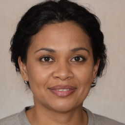 Joyful black adult female with medium  brown hair and brown eyes