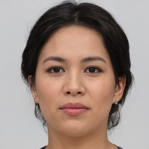 Joyful asian young-adult female with medium  brown hair and brown eyes