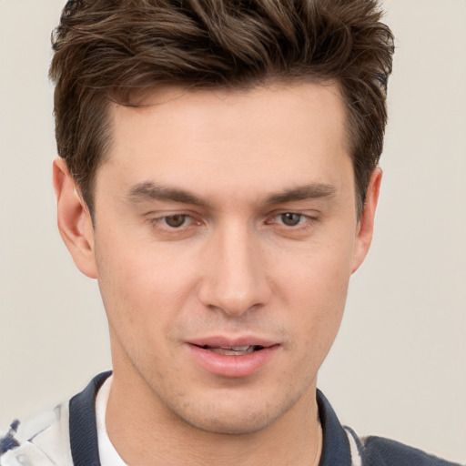 Joyful white young-adult male with short  brown hair and grey eyes