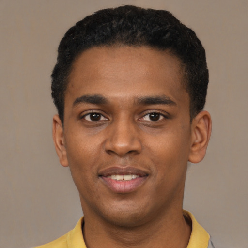 Joyful black young-adult male with short  black hair and brown eyes