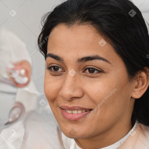 Joyful white adult female with medium  brown hair and brown eyes