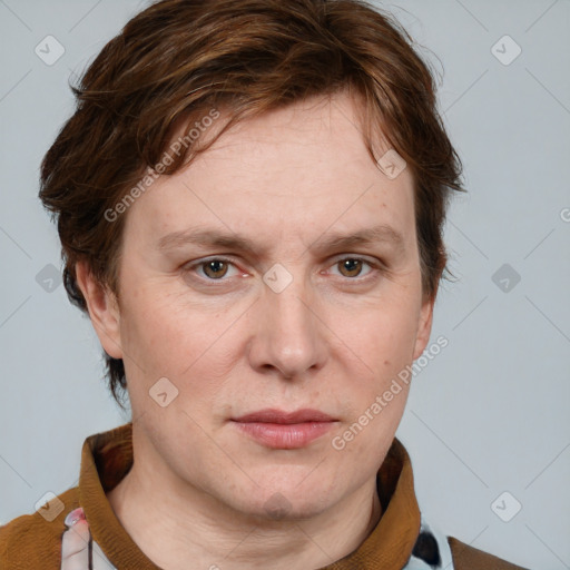 Joyful white adult female with short  brown hair and blue eyes