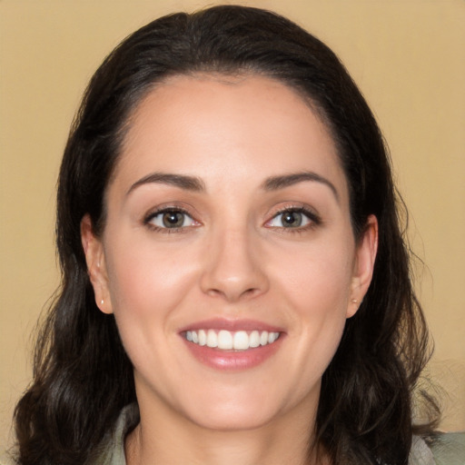 Joyful white young-adult female with long  brown hair and brown eyes