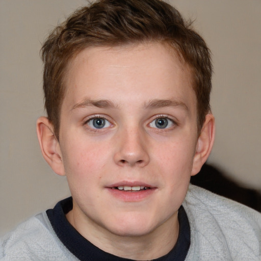 Joyful white child male with short  brown hair and blue eyes