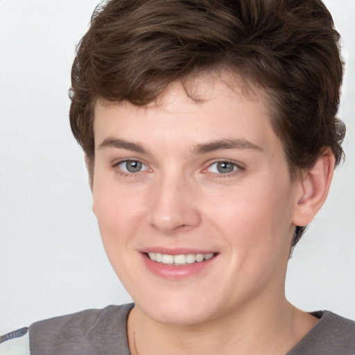 Joyful white young-adult female with short  brown hair and grey eyes