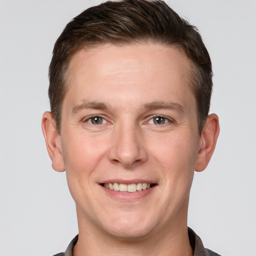 Joyful white adult male with short  brown hair and grey eyes