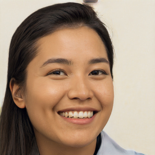 Joyful asian young-adult female with long  brown hair and brown eyes