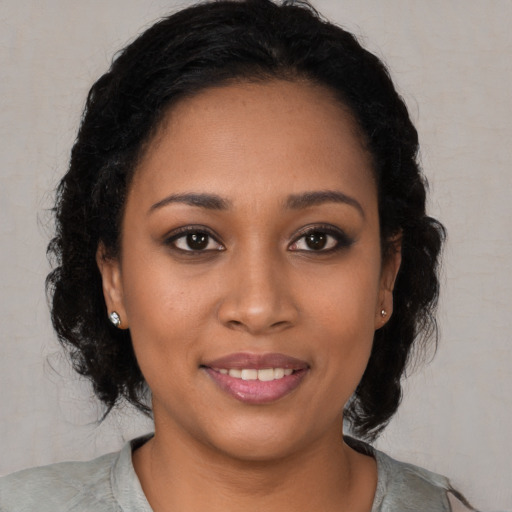 Joyful black young-adult female with medium  black hair and brown eyes