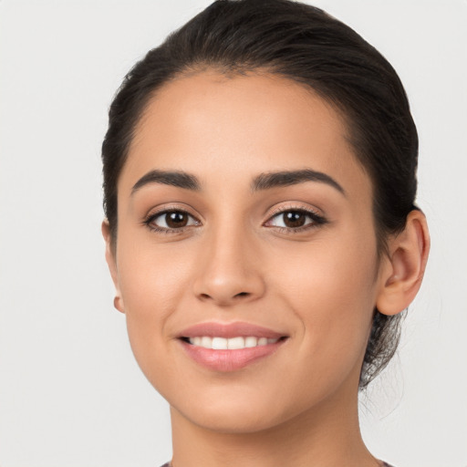 Joyful white young-adult female with long  brown hair and brown eyes