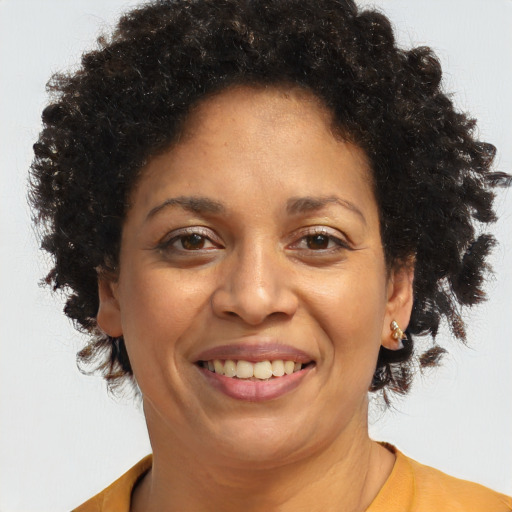 Joyful black adult female with short  brown hair and brown eyes
