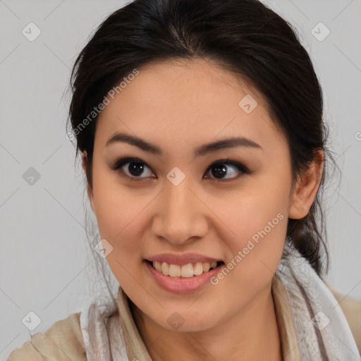 Joyful latino young-adult female with medium  brown hair and brown eyes