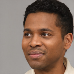 Joyful black young-adult male with short  black hair and brown eyes