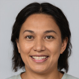 Joyful white adult female with medium  brown hair and brown eyes