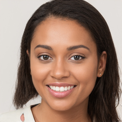 Joyful latino young-adult female with long  brown hair and brown eyes