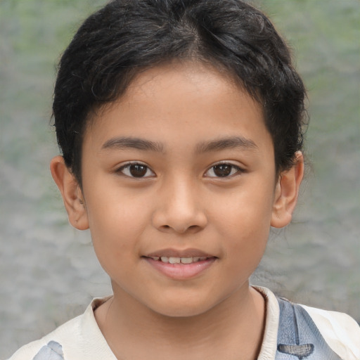 Joyful latino child male with short  brown hair and brown eyes