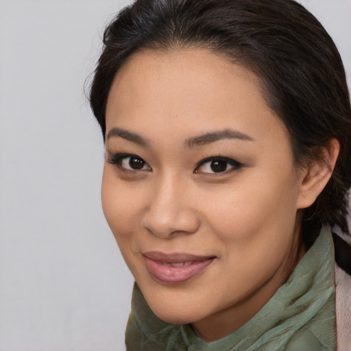 Joyful asian young-adult female with long  brown hair and brown eyes