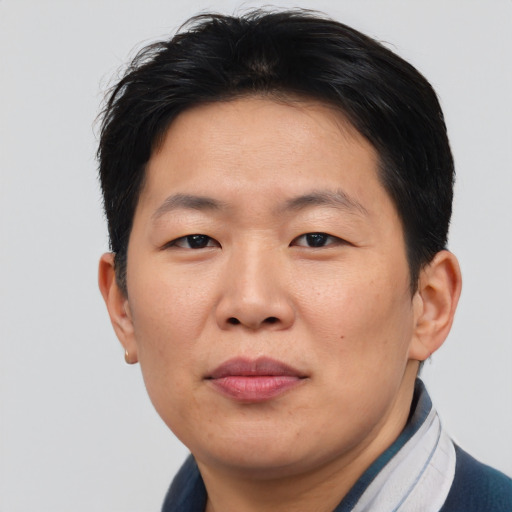 Joyful asian adult male with short  brown hair and brown eyes