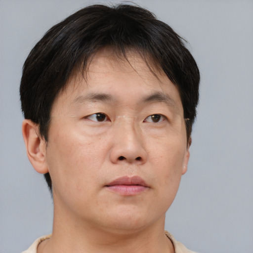 Neutral asian adult male with short  brown hair and brown eyes