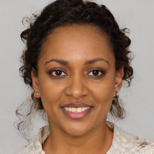 Joyful black young-adult female with medium  brown hair and brown eyes