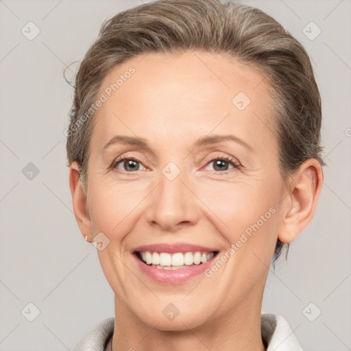 Joyful white adult female with short  brown hair and brown eyes