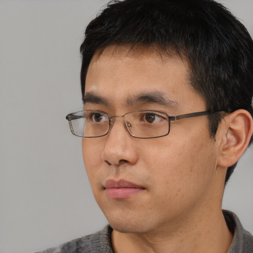 Neutral asian young-adult male with short  black hair and brown eyes