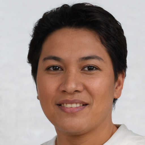 Joyful latino young-adult female with short  brown hair and brown eyes