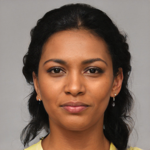 Joyful latino young-adult female with medium  brown hair and brown eyes