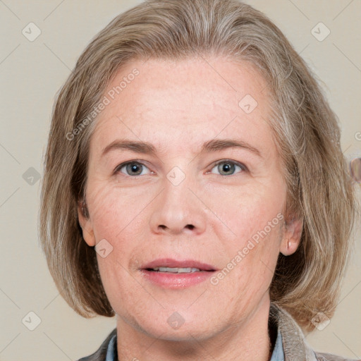 Joyful white adult female with medium  brown hair and blue eyes