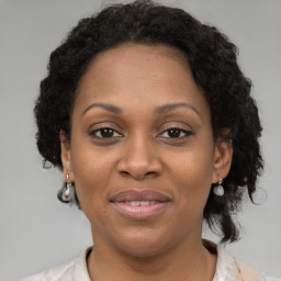 Joyful black adult female with short  brown hair and brown eyes