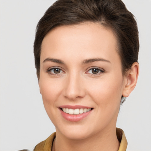 Joyful white young-adult female with short  brown hair and brown eyes