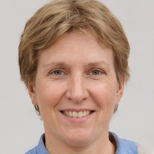 Joyful white adult female with short  brown hair and grey eyes