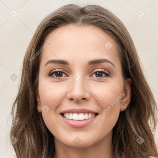 Joyful white young-adult female with long  brown hair and grey eyes