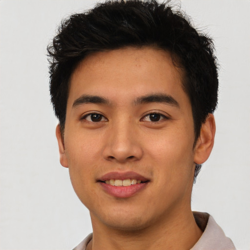 Joyful asian young-adult male with short  brown hair and brown eyes