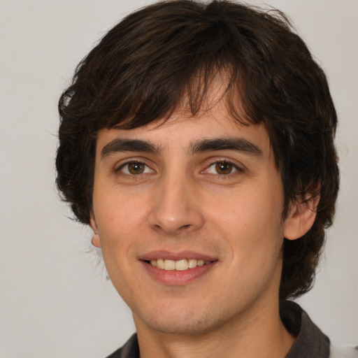 Joyful white young-adult male with medium  brown hair and brown eyes