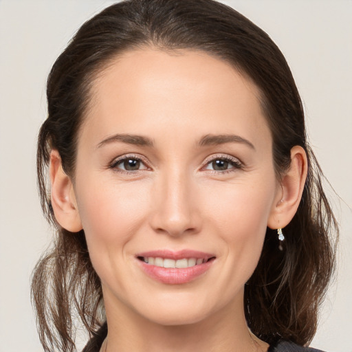 Joyful white young-adult female with medium  brown hair and brown eyes