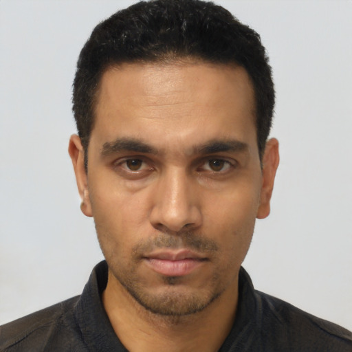 Neutral latino young-adult male with short  black hair and brown eyes