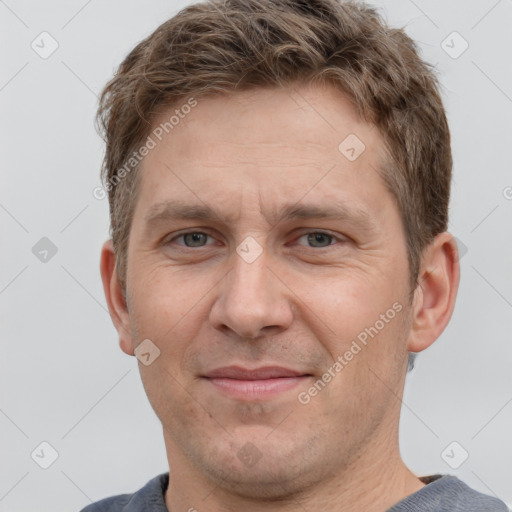 Joyful white adult male with short  brown hair and grey eyes