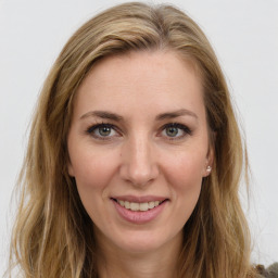 Joyful white young-adult female with long  brown hair and green eyes