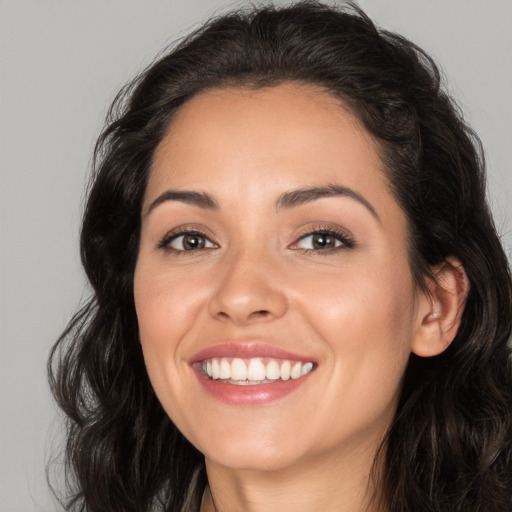 Joyful white young-adult female with long  brown hair and brown eyes