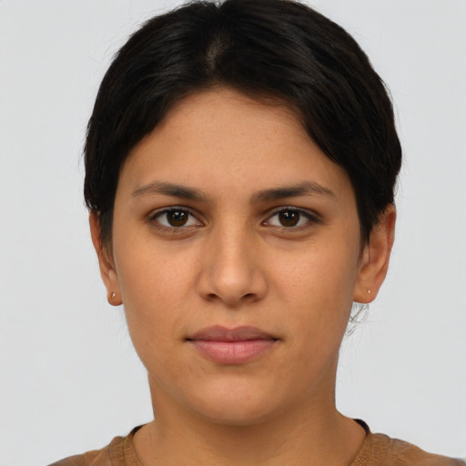Joyful latino young-adult female with short  brown hair and brown eyes